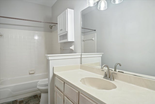 full bathroom featuring vanity, tiled shower / bath combo, and toilet