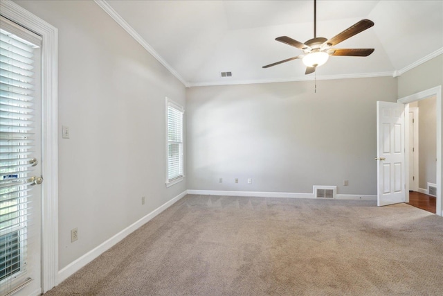 empty room featuring carpet, a healthy amount of sunlight, and vaulted ceiling