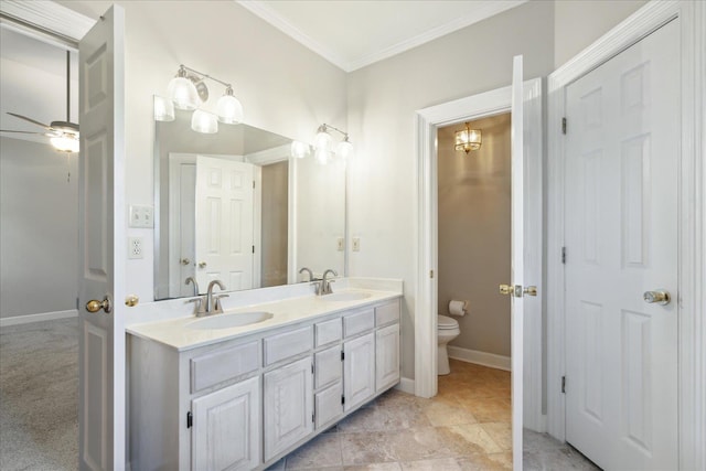 bathroom with ceiling fan, toilet, ornamental molding, and vanity