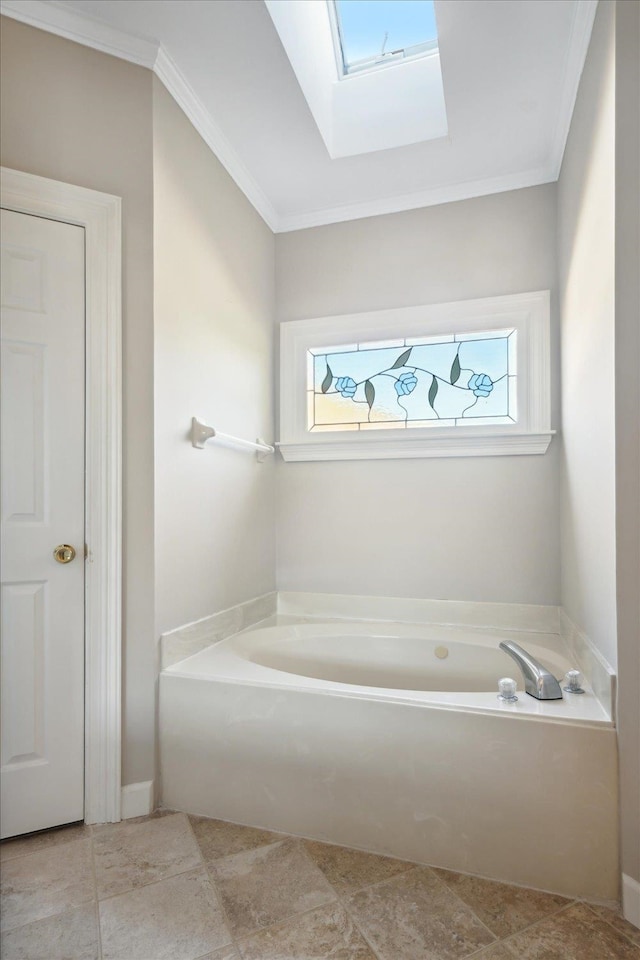 bathroom with a tub to relax in, a skylight, and ornamental molding