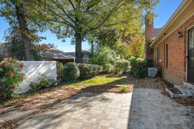 view of yard with central AC and a patio area