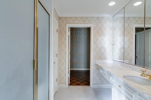 bathroom with tile patterned flooring, vanity, a shower with shower door, and crown molding