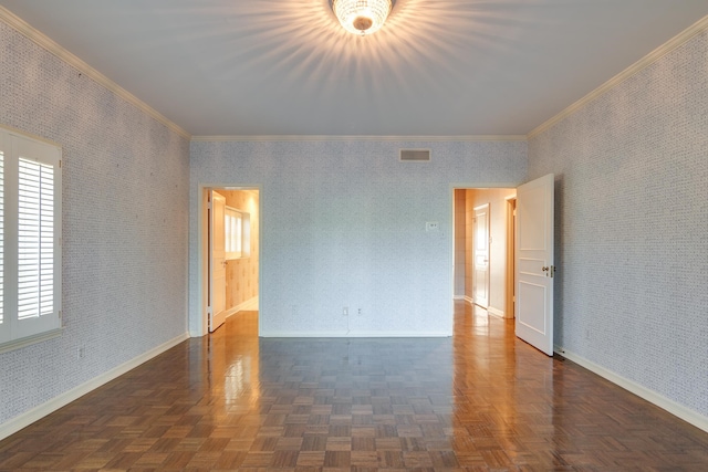 spare room featuring dark parquet floors and ornamental molding