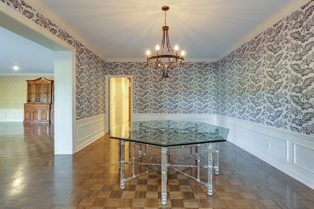 unfurnished dining area featuring a notable chandelier, dark parquet flooring, and ornamental molding