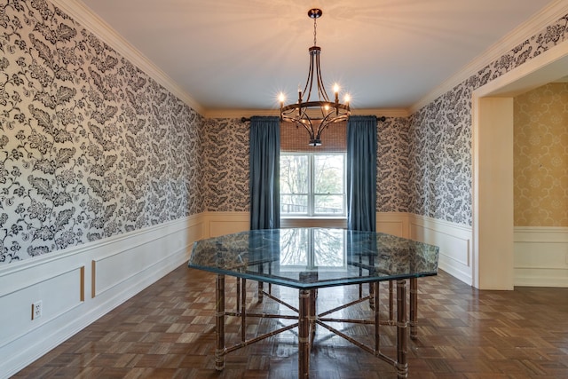 dining area with dark parquet floors, crown molding, and a chandelier