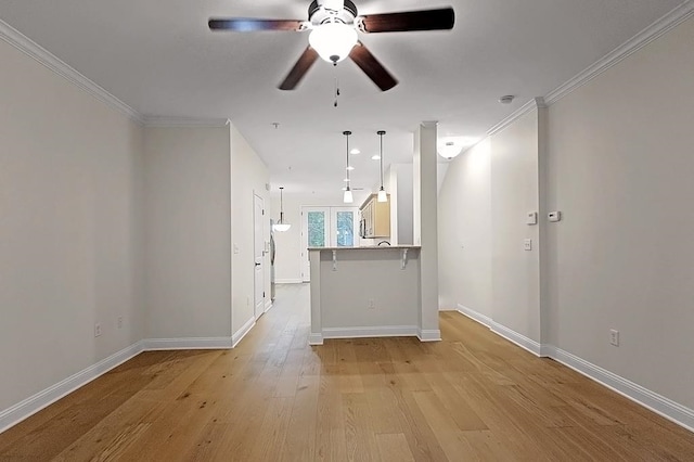 unfurnished living room with crown molding, french doors, ceiling fan, and light wood-type flooring