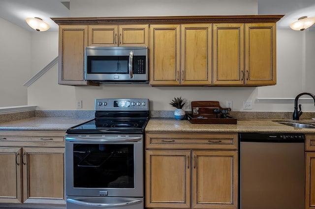 57 W Georgia Ave W Unit 102, Memphis, TN 38103 - kitchen featuring appliances with stainless steel finishes, brown cabinets, and light countertops