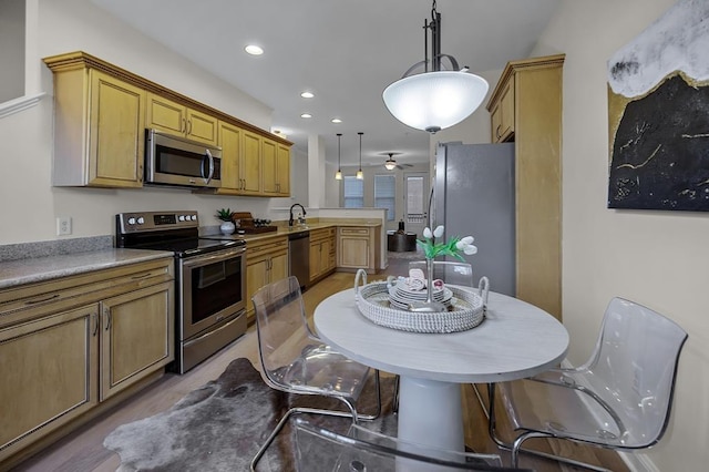 57 W Georgia Ave W Unit 102, Memphis, TN 38103 - kitchen featuring stainless steel appliances, a peninsula, decorative light fixtures, ceiling fan, and recessed lighting
