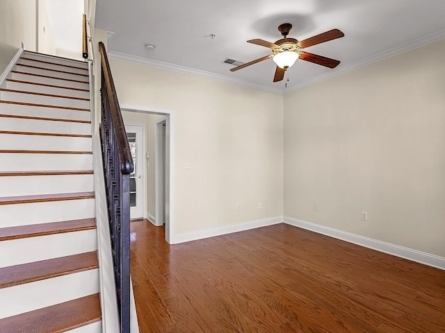 stairway with wood-type flooring, ceiling fan, and crown molding