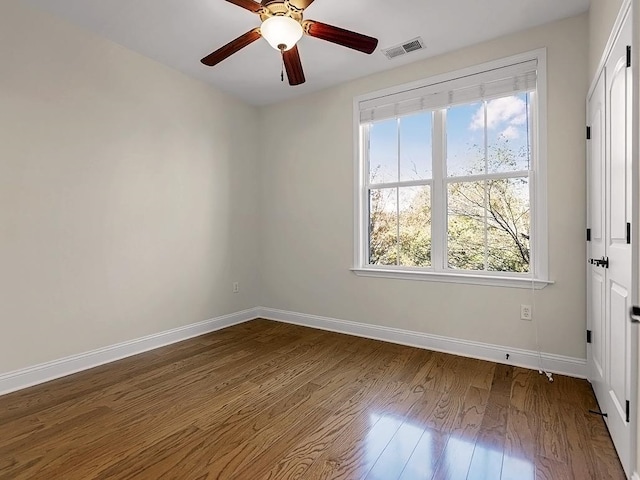 spare room featuring hardwood / wood-style floors and ceiling fan