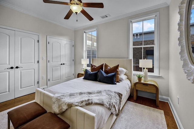 57 W Georgia Ave W Unit 102, Memphis, TN 38103 - bedroom with multiple closets, wood finished floors, ornamental molding, and ceiling fan
