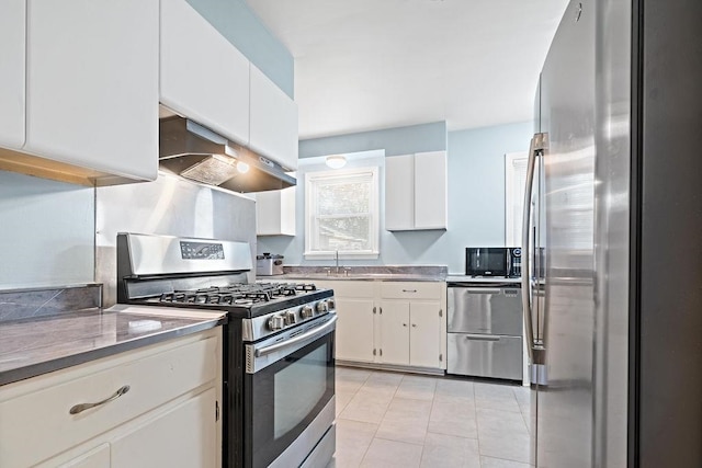 kitchen with white cabinets, sink, range hood, light tile patterned flooring, and stainless steel appliances