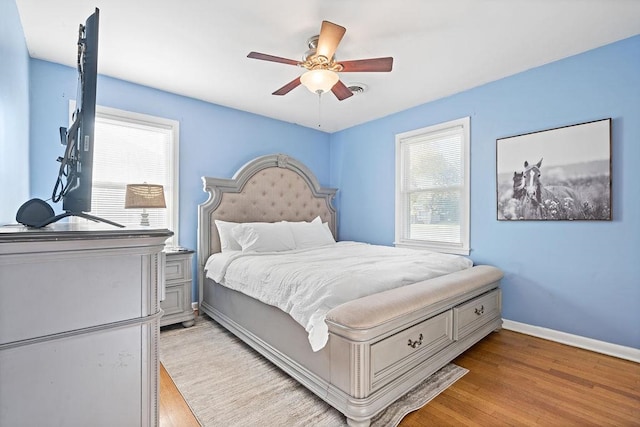 bedroom featuring light hardwood / wood-style floors and ceiling fan