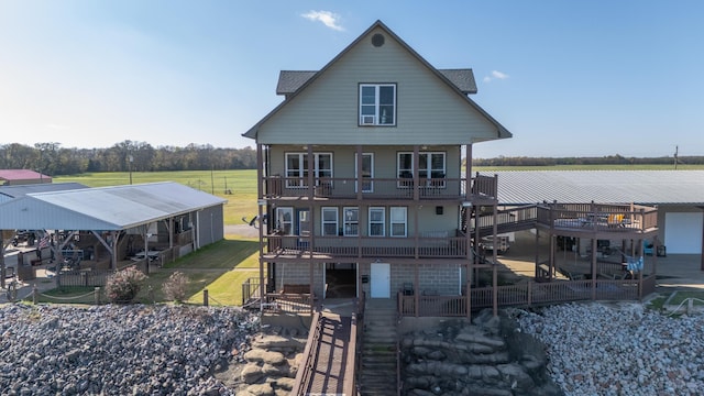 back of property featuring a deck and a yard