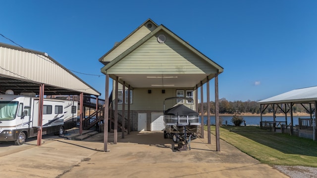 exterior space featuring a water view and a carport