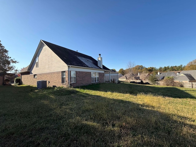 view of property exterior featuring a yard and central AC unit