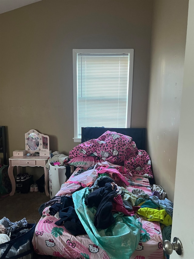 carpeted bedroom with lofted ceiling