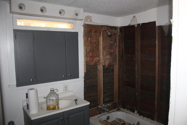 bathroom featuring vanity, a textured ceiling, and tub / shower combination