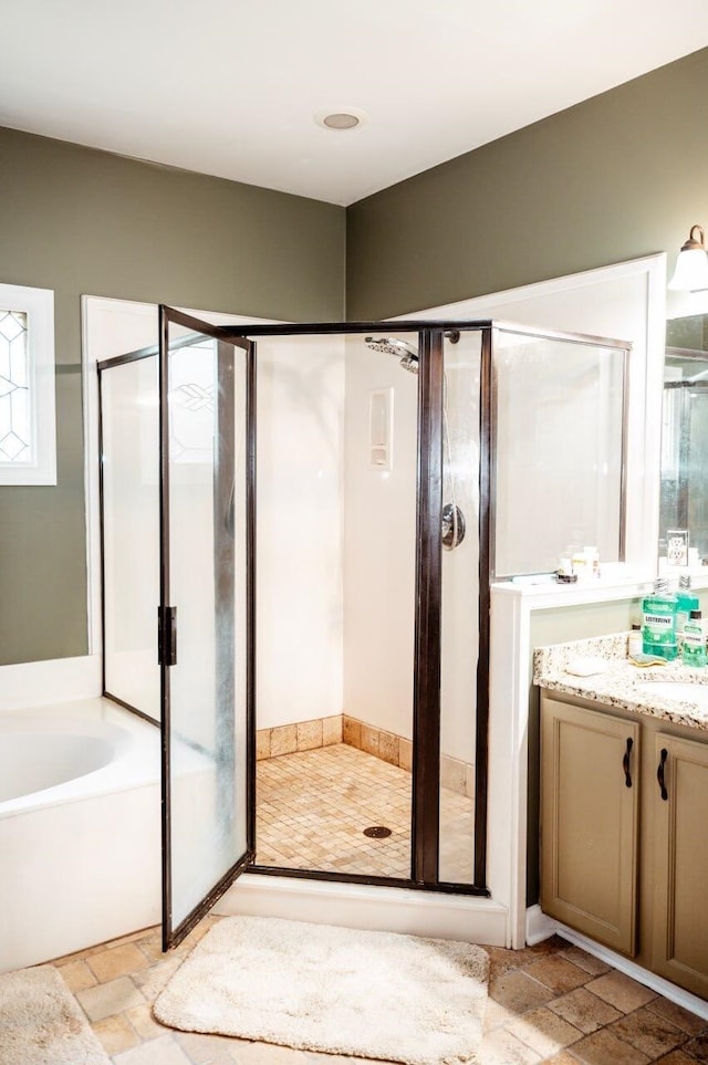 bathroom with vanity and independent shower and bath