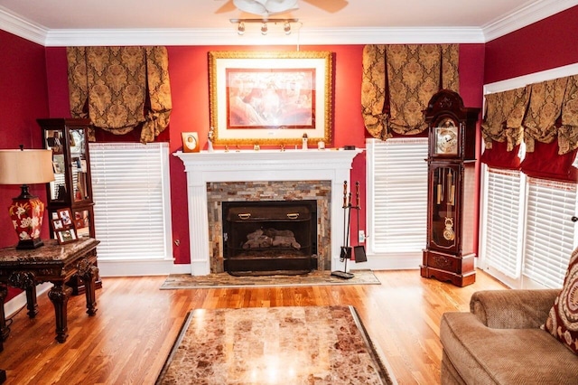 sitting room with ceiling fan, wood-type flooring, and ornamental molding