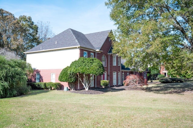 view of side of home featuring a lawn