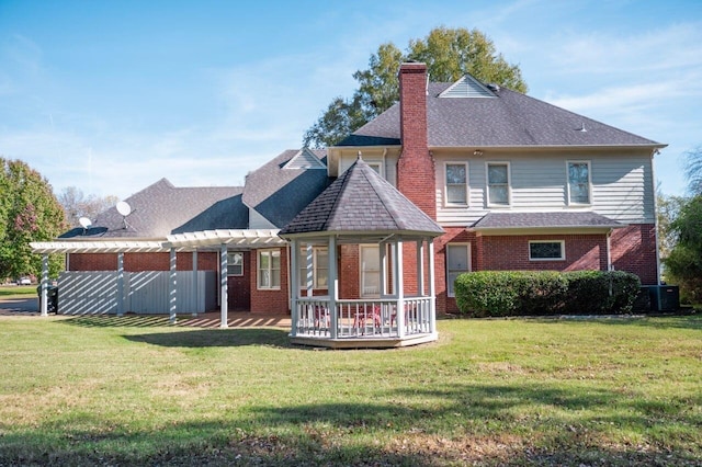 back of house with a yard, a wooden deck, and central air condition unit