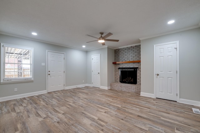 unfurnished living room featuring a fireplace, light hardwood / wood-style floors, ceiling fan, and ornamental molding