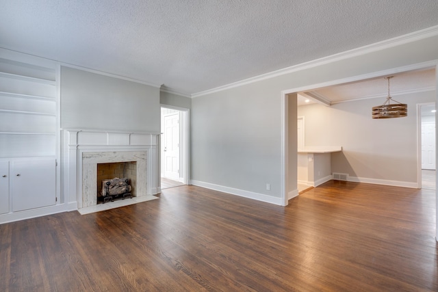 unfurnished living room with a premium fireplace, dark wood-type flooring, a textured ceiling, and ornamental molding