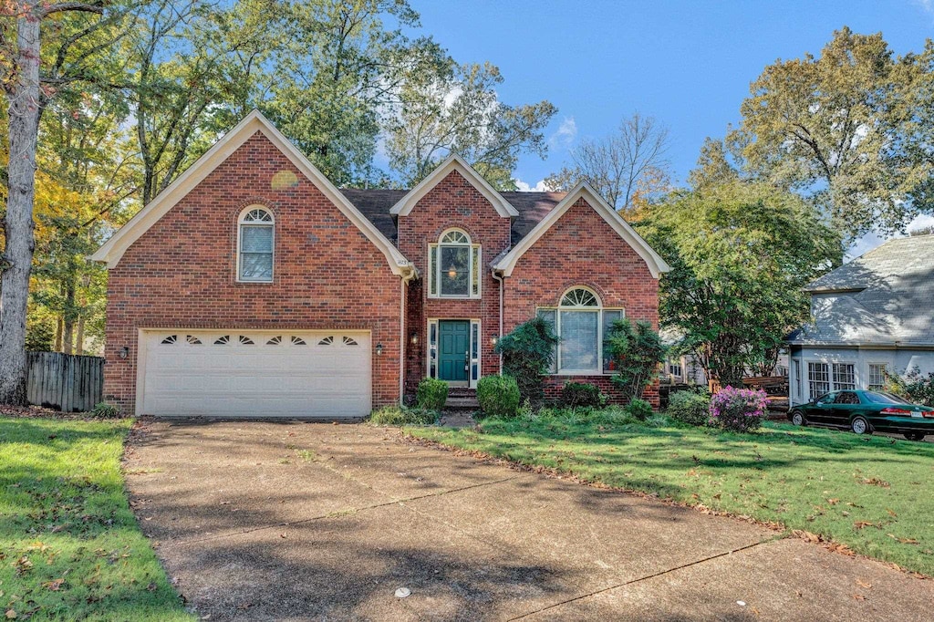 front facade featuring a garage and a front lawn