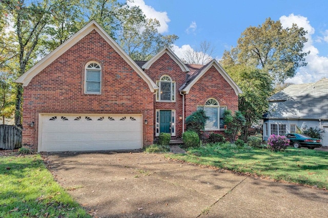 view of property featuring a front lawn and a garage