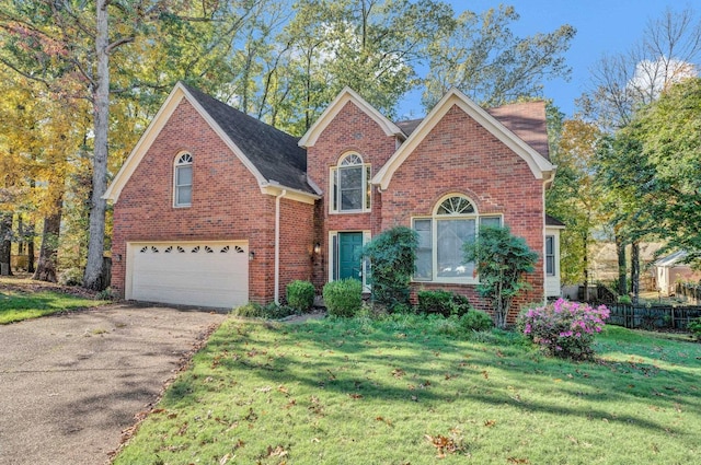 front facade featuring a garage and a front lawn