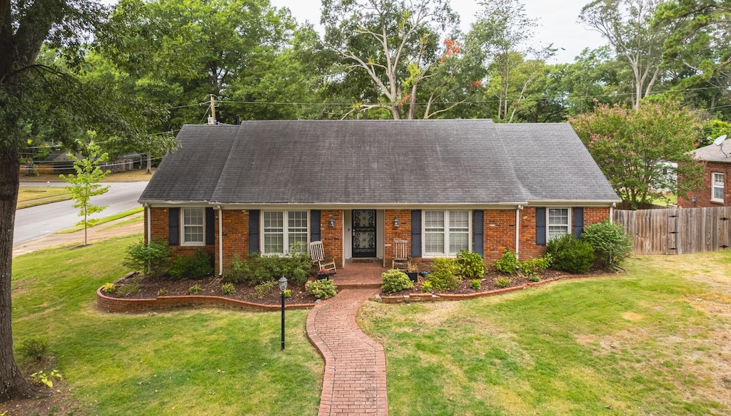 new england style home featuring a front lawn