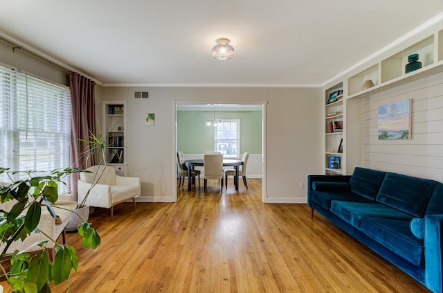 living room featuring light hardwood / wood-style floors and ornamental molding