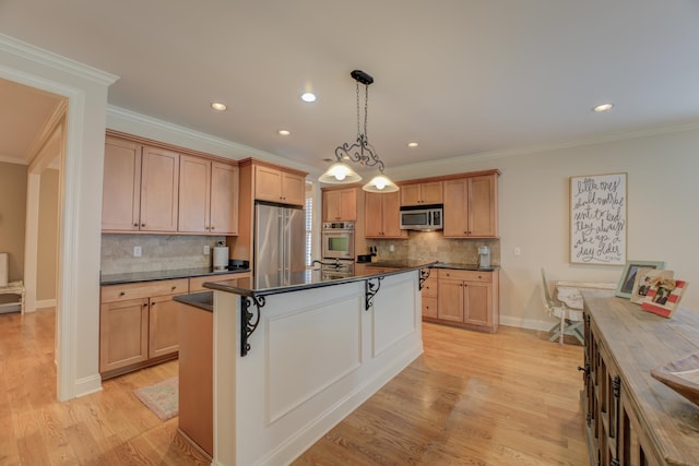 kitchen featuring a center island, decorative light fixtures, light hardwood / wood-style floors, and stainless steel appliances