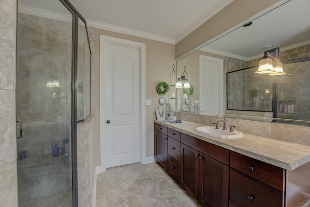 bathroom with vanity, an enclosed shower, and crown molding