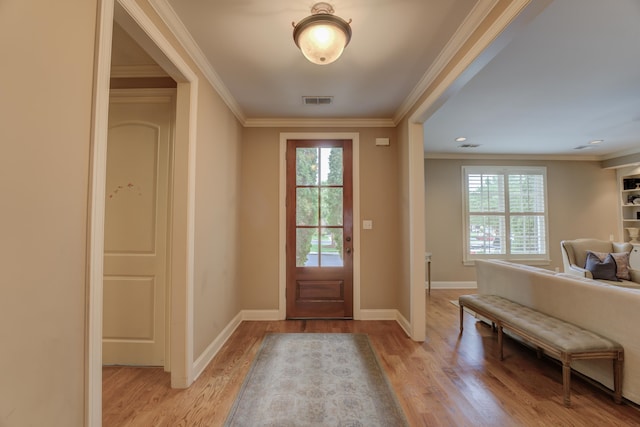 doorway to outside featuring light hardwood / wood-style flooring and ornamental molding