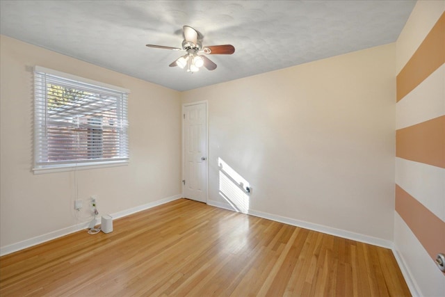 spare room with ceiling fan and light hardwood / wood-style flooring