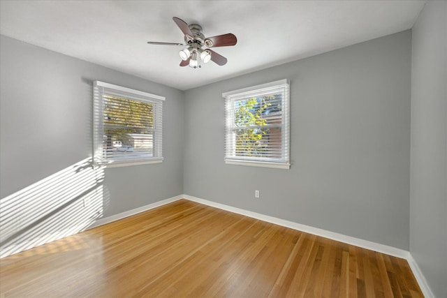 spare room featuring hardwood / wood-style floors and ceiling fan