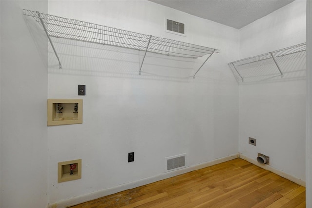 laundry room featuring electric dryer hookup, washer hookup, and hardwood / wood-style floors