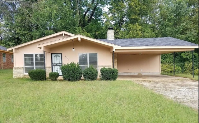 view of front of house with a front lawn and a carport