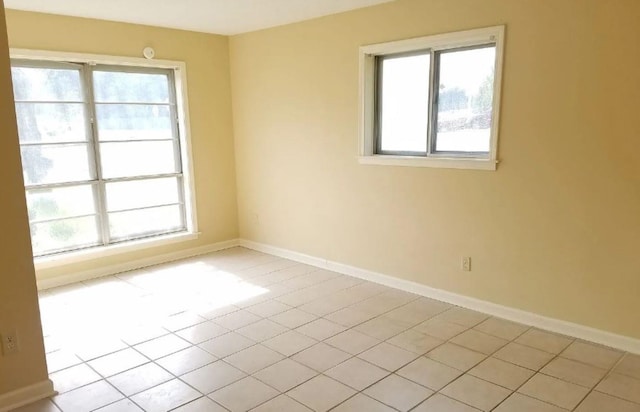 tiled spare room with plenty of natural light