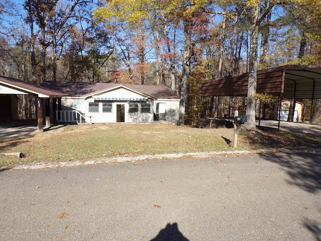 view of front of house with a front lawn and a carport