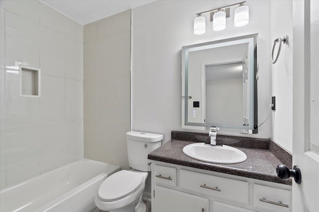 full bathroom with a textured ceiling, vanity, toilet, and tiled shower / bath combo