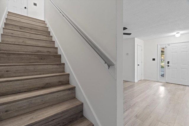 entrance foyer featuring a textured ceiling and light hardwood / wood-style floors