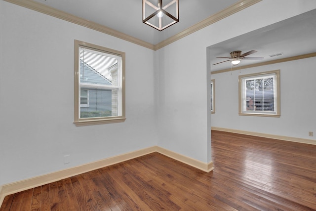 unfurnished room featuring hardwood / wood-style flooring, a healthy amount of sunlight, and crown molding