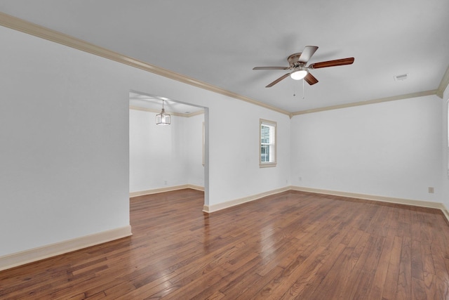 spare room featuring dark hardwood / wood-style floors, ceiling fan, and ornamental molding