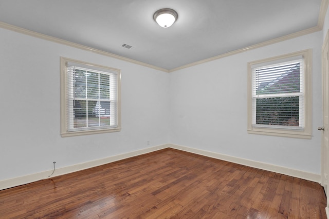 spare room with crown molding, hardwood / wood-style floors, and a healthy amount of sunlight