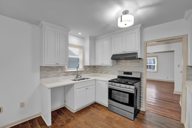 kitchen with white cabinets, gas range, hardwood / wood-style flooring, and a healthy amount of sunlight