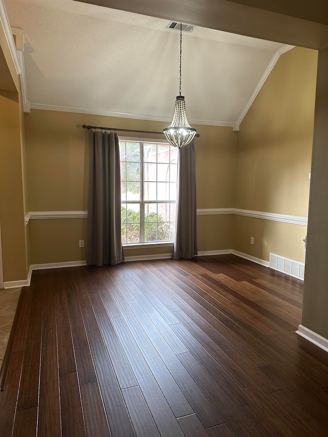 spare room featuring a textured ceiling, vaulted ceiling, crown molding, dark wood-type flooring, and a notable chandelier