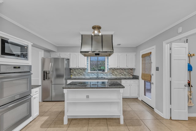 kitchen featuring light tile patterned floors, crown molding, dark stone counters, white cabinets, and appliances with stainless steel finishes